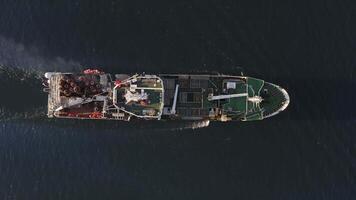 View from the drone vertically down on a fishing trawler at sea on the move video