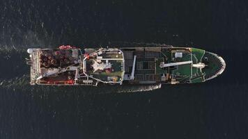 View from the drone vertically down on a fishing trawler at sea on the move video