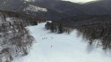 Aerial view of a group of snowboarders descending the ski slope video