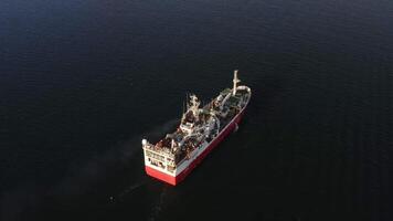 View from the drone vertically down on a fishing trawler at sea on the move video