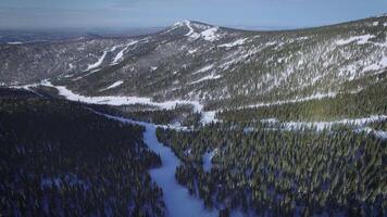 Drone view on the snow mountain with trails in a ski resort. video