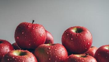 A group of red apples with water droplets on them. photo