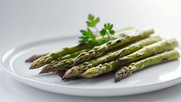 Grilled asparagus served with a fresh herb garnish photo