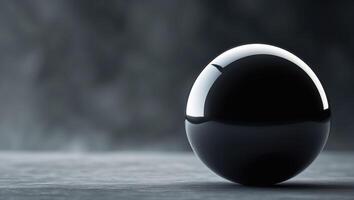 Large black sphere is in the middle of a dark background.Large black sphere is in the middle of a dark background. photo
