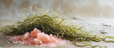 Beautiful flat lay of seaweed and pink salt on a textured background with a calming aesthetic photo