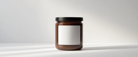 Brown Glass Jar with Black Lid and Blank Label for Product Display photo