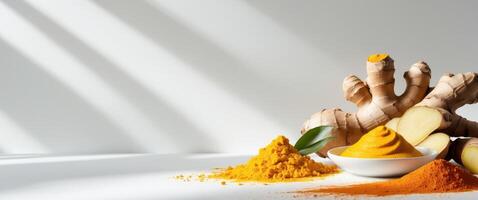 Fresh turmeric paste arranged beautifully with ginger and turmeric powder on a bright background photo