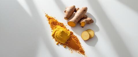 Fresh turmeric paste arranged beautifully with ginger and turmeric powder on a bright backgroundFresh turmeric paste arranged beautifully with ginger and turmeric powder on a bright background. photo