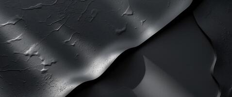Textured black surface with subtle variations in light and shadowTextured black surface with subtle variations in light and shadow. photo