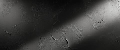 Black and white photo of a wall with a light shining on it