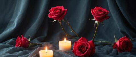 Tranquil candlelight and three red roses on dark fabric backgroundTranquil candlelight and three red roses on dark fabric background. photo