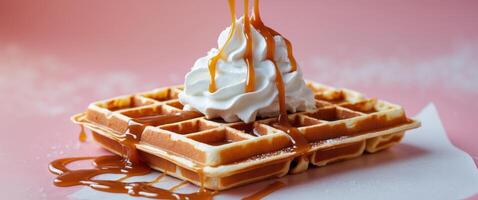 waffles with whipped cream and caramel on the pink backgroundwaffles with whipped cream and caramel on the pink background. photo