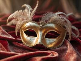 Golden Venetian mask with feathers resting on rich red fabric photo