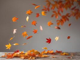 Scene featuring autumn leaves scattering across a rustic wooden tableScene featuring autumn leaves scattering across a rustic wooden table. photo