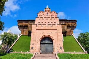 The reconstructed building of the ancient Golden Gate in the center of Kyiv against the blue sky on a summer day. August 21, 2022 Kyiv, Ukraine. photo