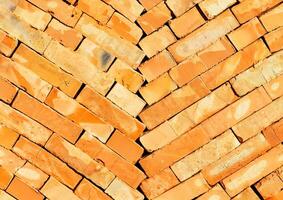 Orange building bricks are stacked diagonally in two columns towards the center. photo