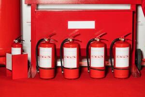 Fire shield with fire extinguishers standing in a row. photo