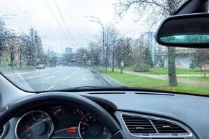 View from the car interior on rainy weather in early spring. photo