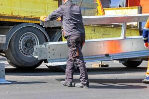 Installation of a demarcation barrier on the carriageway. photo