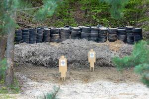 Wooden targets in a shooting range set up in a forest ravine. photo
