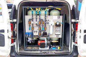 Portable water filtration system in van, showcasing industrial design and functionality of filtration equipment, water purification, technology concept photo