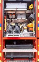 Detailed view, organized firefighting equipment in fire truck storage compartments, essential rescue gear, emergency response tools image, firefighting concept photo