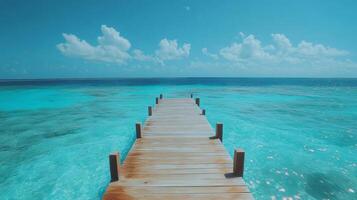 Wooden pier stretching into the turquoise ocean paradise under a cloudy sky photo