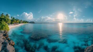 Tropical white sand beach and azure ocean reflecting setting sun with palm trees and pier photo