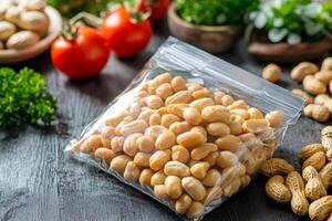 Roasted peanuts in resealable bag with tomatoes and parsley on rustic table photo