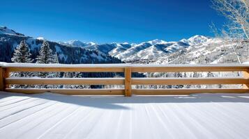 stunning snowy winter scene with mountains and wooden railing photo
