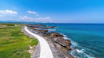 stunning coastline with winding path along rocky shores and clear blue waters photo