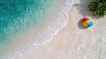 Aerial view of beach with turquoise water and colorful beach ball photo