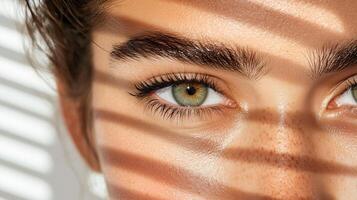 Captivating close up of woman eye with striking green color and shadows photo