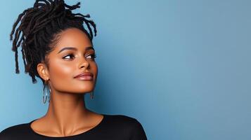stunning woman with dreadlocks poses against blue background photo