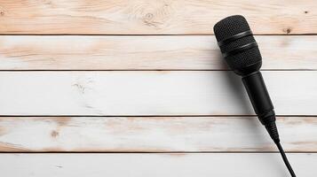 High quality black microphone on wooden background, perfect for audio photo
