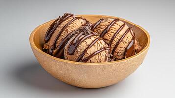 Delicious chocolate ice cream scoops in wooden bowl, drizzled with syrup photo