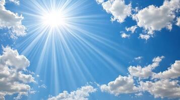 Bright sun shining through fluffy clouds in clear blue sky photo
