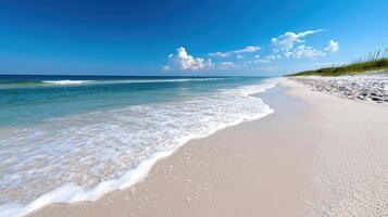 Peaceful beach with soft sand and gentle waves under clear blue sky photo