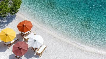Colorful beach umbrellas on sandy shore with clear water photo