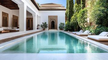 Luxurious villa with serene pool surrounded by lush greenery and architecture photo