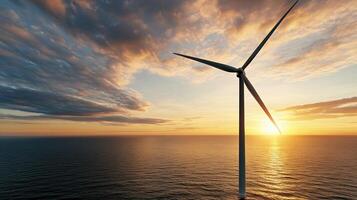 High resolution image of wind turbine at sunset over ocean photo