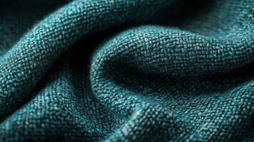 Close-up view of textured teal fabric showcasing intricate weave patterns photo