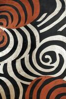 Bold abstract design featuring swirls and stripes in red, black, and white photo