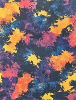 Vibrant abstract pattern featuring splashes of color on a dark background photo