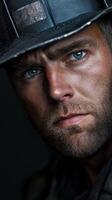 Miner with intense gaze showcasing hard work and dedication in the industry photo