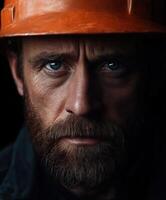 Miner with orange helmet displaying intense expression and determination photo