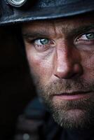 Miner with striking blue eyes focused on the task ahead in a dimly lit mine photo