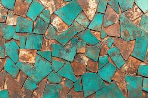 Mosaic of turquoise and brown tiles creating a vibrant textured pattern photo