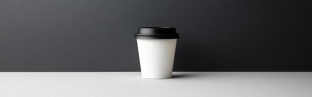Minimalist coffee cup on a table against a dark background photo