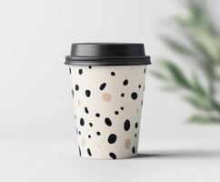 Stylish coffee cup with modern design on neutral background photo